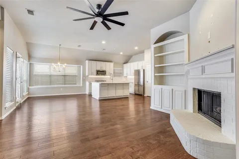 a view of a kitchen with a stove cabinets and wooden floor