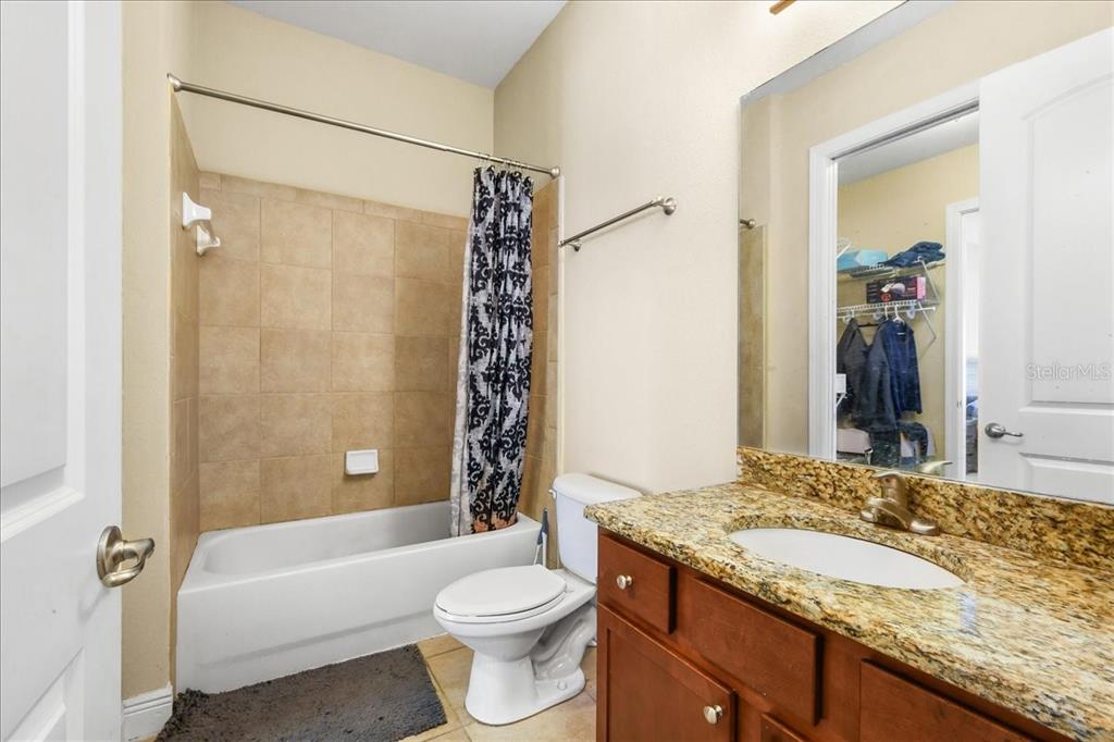 230 Southwest 2nd Avenue, Unit 207 Gainesville, FL 32601 - Photo 11 of 25 a bathroom with a granite countertop sink toilet and shower