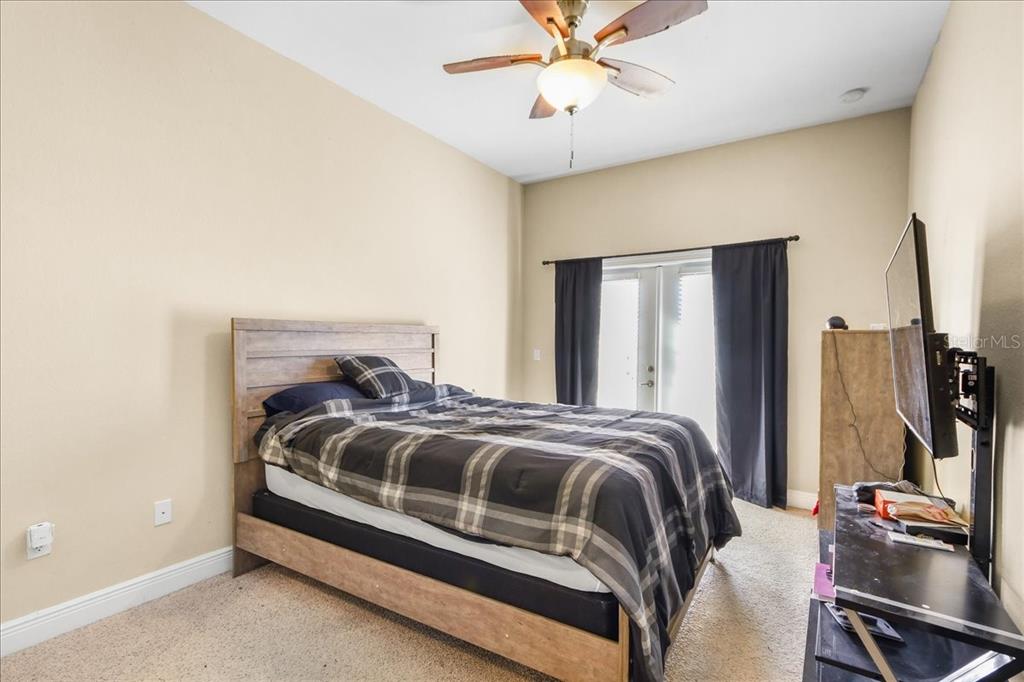 230 Southwest 2nd Avenue, Unit 207 Gainesville, FL 32601 - Photo 12 of 25 a bedroom with a bed and a chandelier