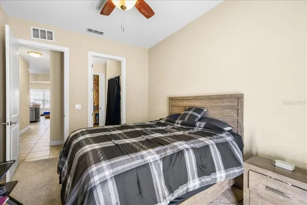 a bedroom with a bed and a chandelier