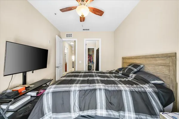 a bedroom with a bed and a flat screen tv