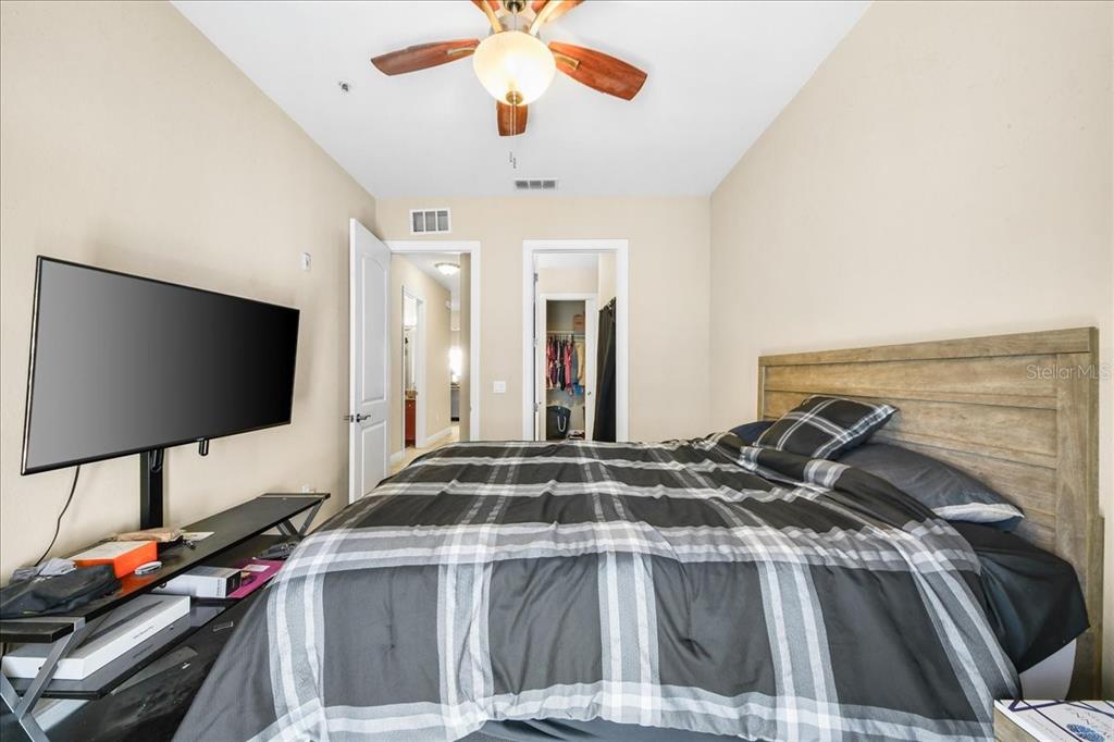 230 Southwest 2nd Avenue, Unit 207 Gainesville, FL 32601 - Photo 14 of 25 a bedroom with a bed and a flat screen tv