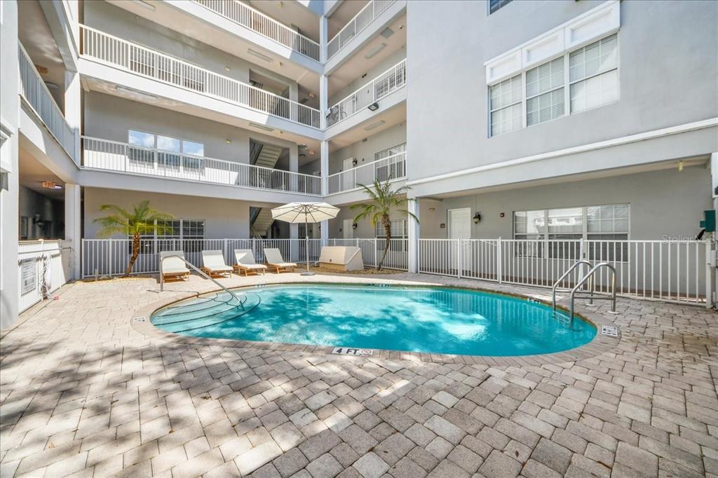 230 Southwest 2nd Avenue, Unit 207 Gainesville, FL 32601 - Photo 20 of 25 a swimming pool with outdoor seating