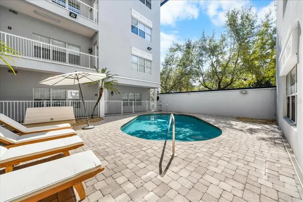 a backyard of a house with table and chairs