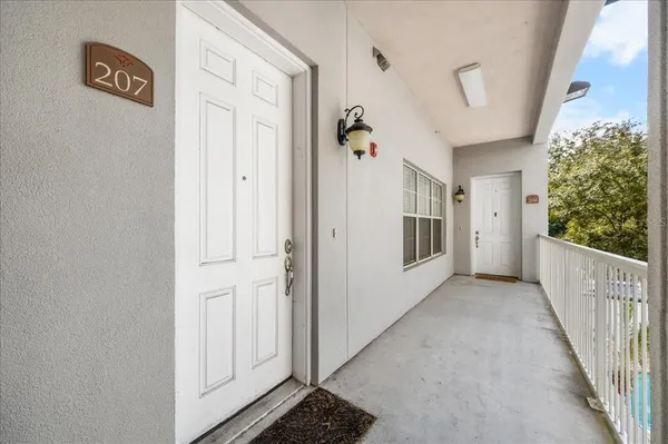 a view of a hallway with wooden floor and entryway