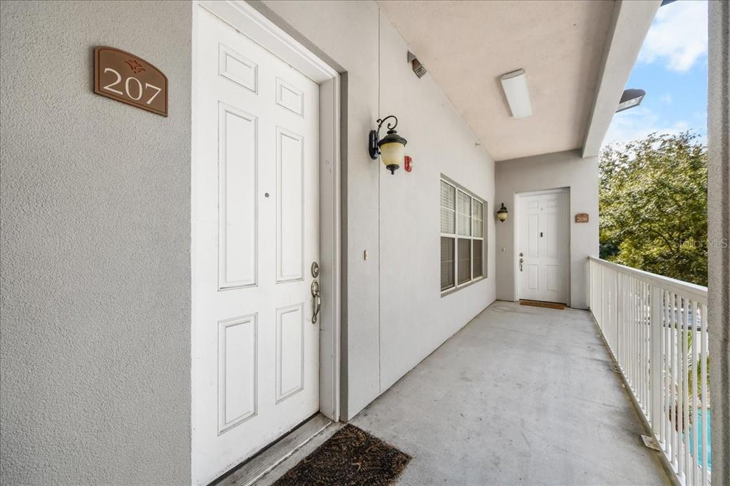230 Southwest 2nd Avenue, Unit 207 Gainesville, FL 32601 - Photo 24 of 25 a view of a hallway with wooden floor and entryway