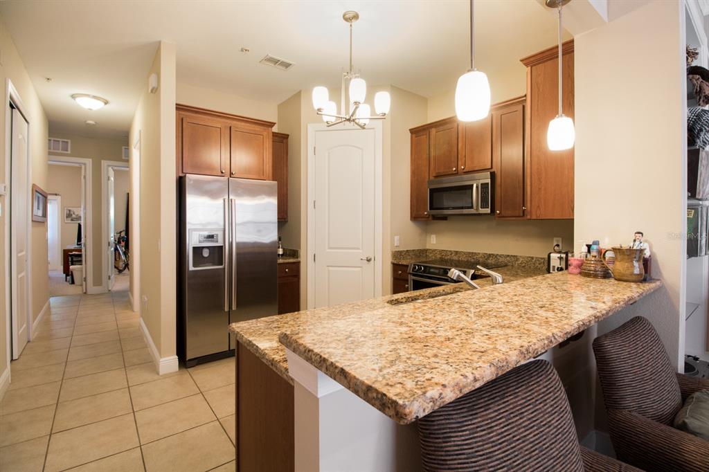 230 Southwest 2nd Avenue, Unit 207 Gainesville, FL 32601 - Photo 3 of 25 a kitchen with a refrigerator a sink and a refrigerator