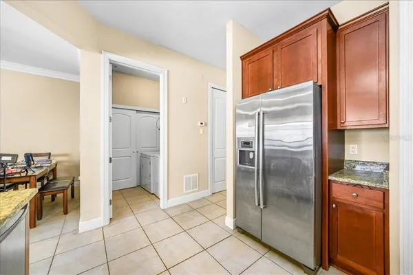 a kitchen with a refrigerator a stove a washer and dryer