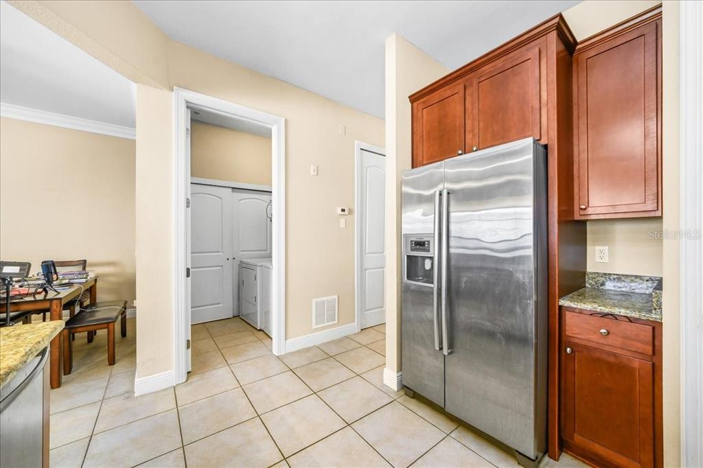 230 Southwest 2nd Avenue, Unit 207 Gainesville, FL 32601 - Photo 6 of 25 a kitchen with a refrigerator a stove a washer and dryer