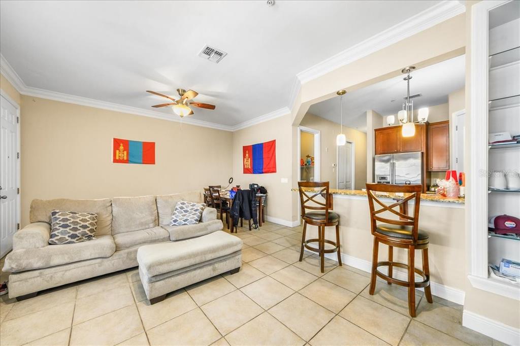 230 Southwest 2nd Avenue, Unit 207 Gainesville, FL 32601 - Photo 7 of 25 a living room with furniture and a chandelier