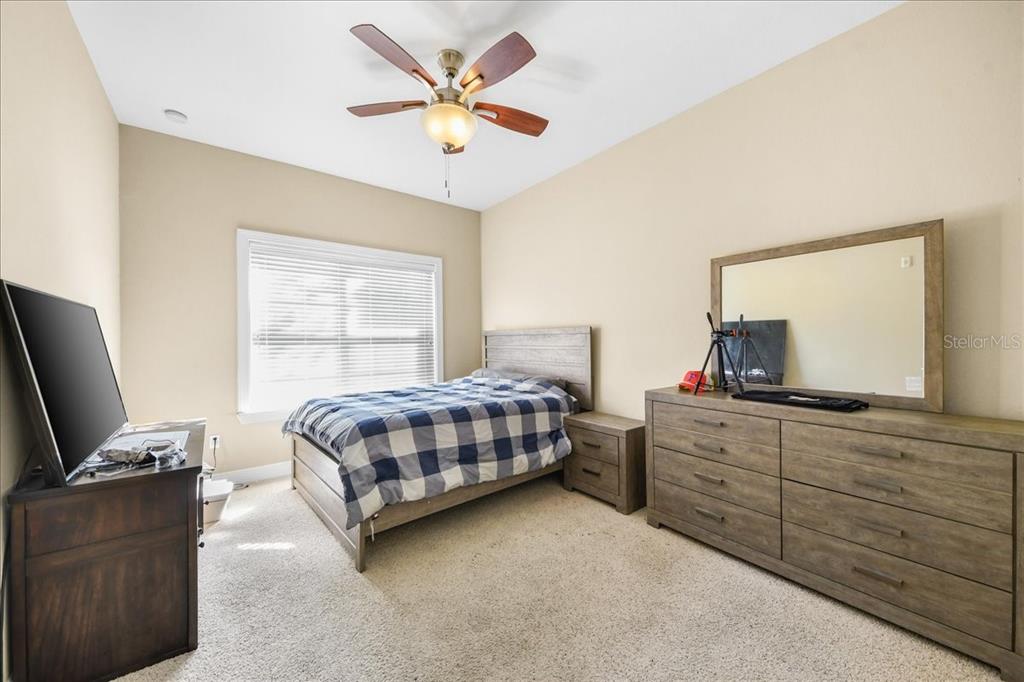 230 Southwest 2nd Avenue, Unit 207 Gainesville, FL 32601 - Photo 9 of 25 a bedroom with a bed and a flat screen tv