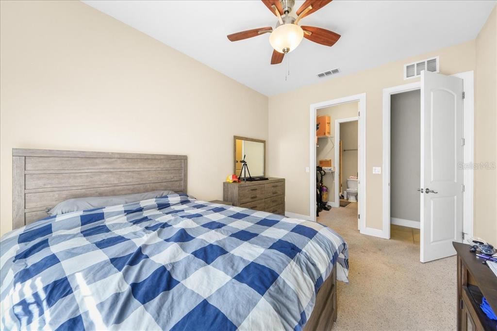 230 Southwest 2nd Avenue, Unit 207 Gainesville, FL 32601 - Photo 10 of 25 a bedroom with a bed and a chandelier