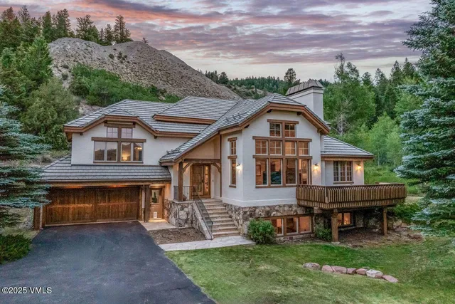 a front view of a house with a garden