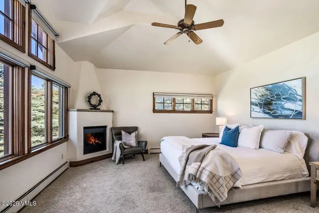 a spacious bedroom with a bed and a fireplace