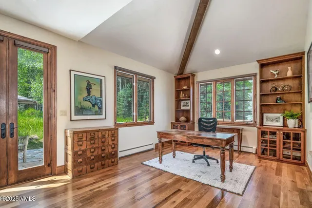 a living room with furniture and a floor to ceiling window