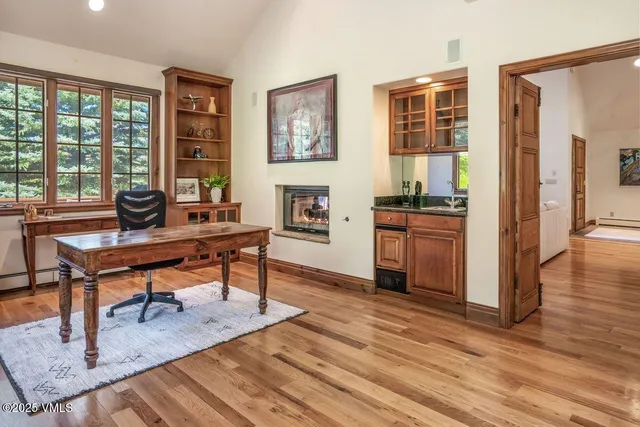 a workspace with furniture window and wooden floor