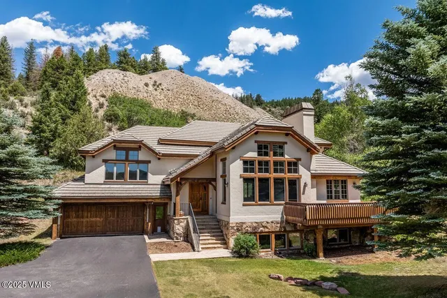 a front view of a house with a yard and balcony