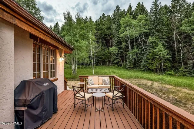a view of a patio with table and chairs and wooden floor
