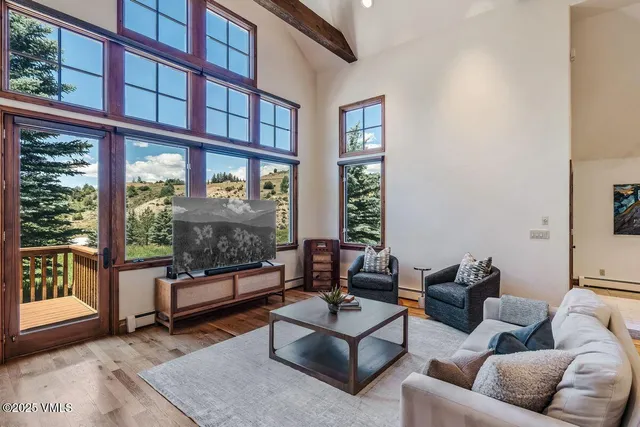 a living room with furniture and a floor to ceiling window