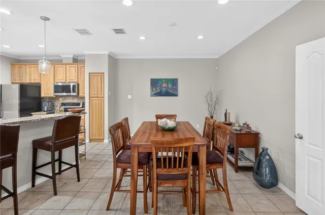a kitchen with stainless steel appliances granite countertop a refrigerator and a stove top oven