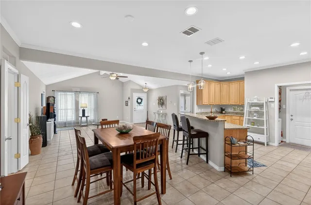 a kitchen with stainless steel appliances kitchen island granite countertop a refrigerator and microwave