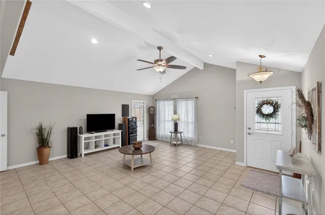 a living room with lots of furniture and view of kitchen