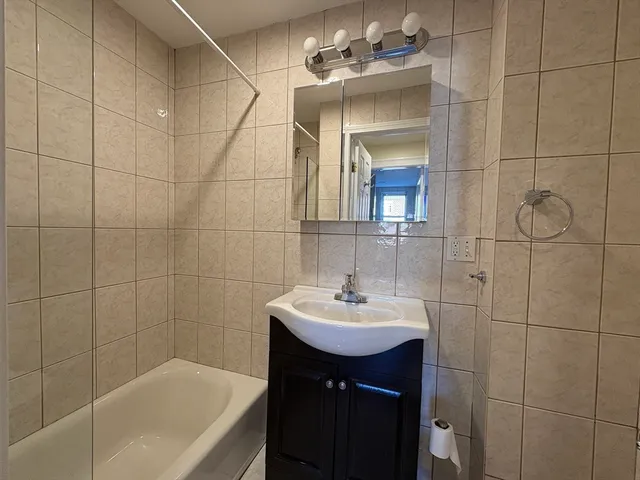 a bathroom with a sink shower and a bathtub