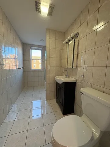 a bathroom with a toilet a sink a mirror and bathtub