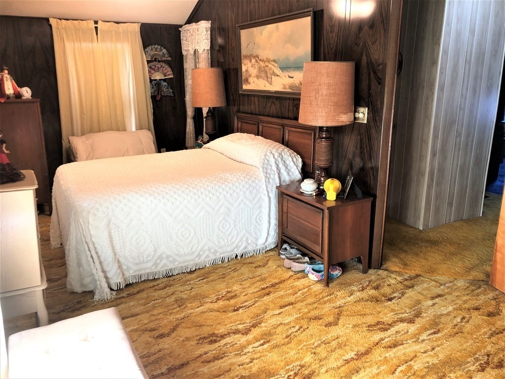 103 Turner Road Scituate, MA 02066 - Photo 9 of 15 a bedroom with a bed and dresser with mirror