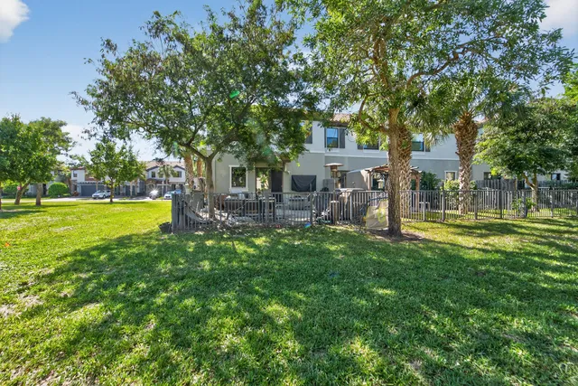 a backyard of a house with table and chairs