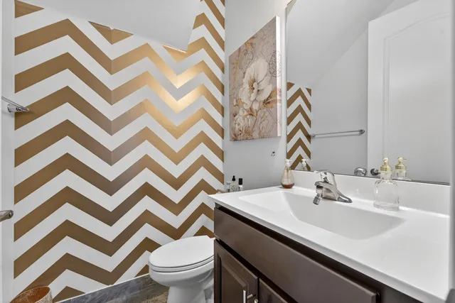 a bathroom with a sink and a mirror with toilet