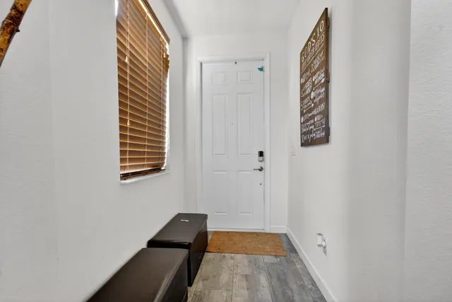 a view of a room with wooden floor and a window