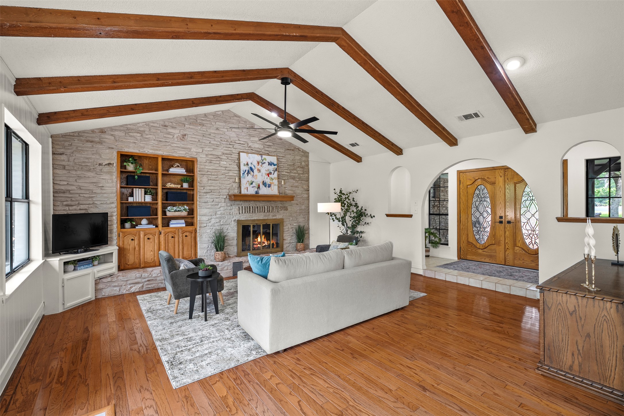 303 West Sequoia Spur Georgetown, TX 78628 - Photo 8 of 34 a living room with fireplace furniture flat screen tv and wooden floor
