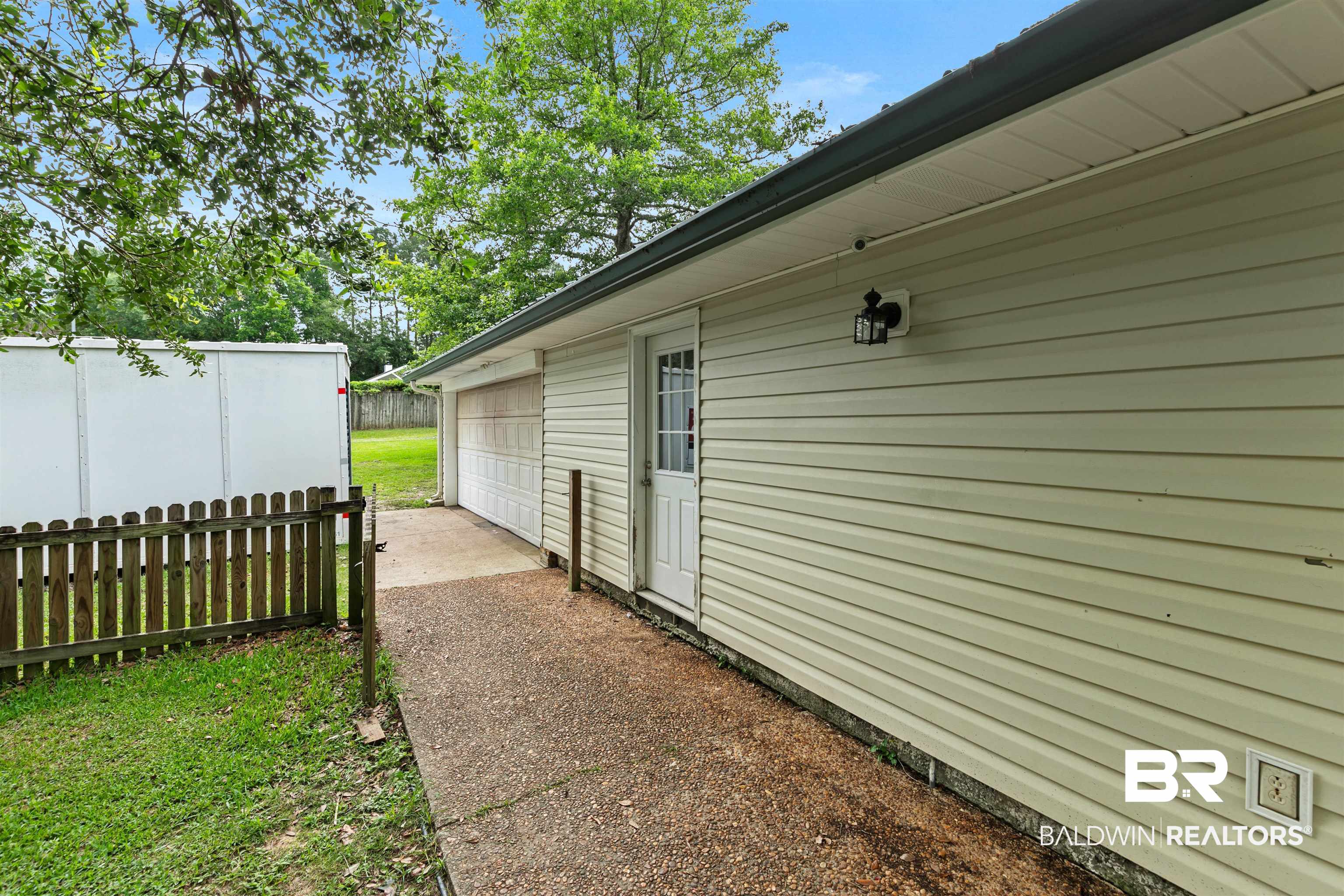 10420 Johnson Road South Mobile, AL 36695 - Photo 64 of 75 Vinyl siding exterior with a metal roof and an attached garage