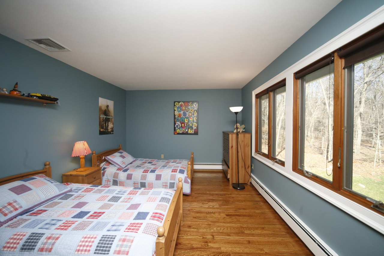 51 Journeys End Road New Canaan, CT 06840 - Photo 11 of 17 a bed room with a bed and a large window