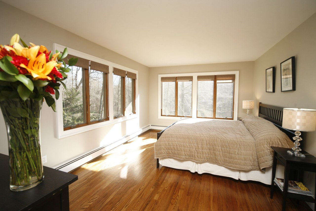 51 Journeys End Road New Canaan, CT 06840 - Photo 10 of 17 a bedroom with a bed and a large window with outer view