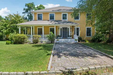 a front view of a house with garden and porch