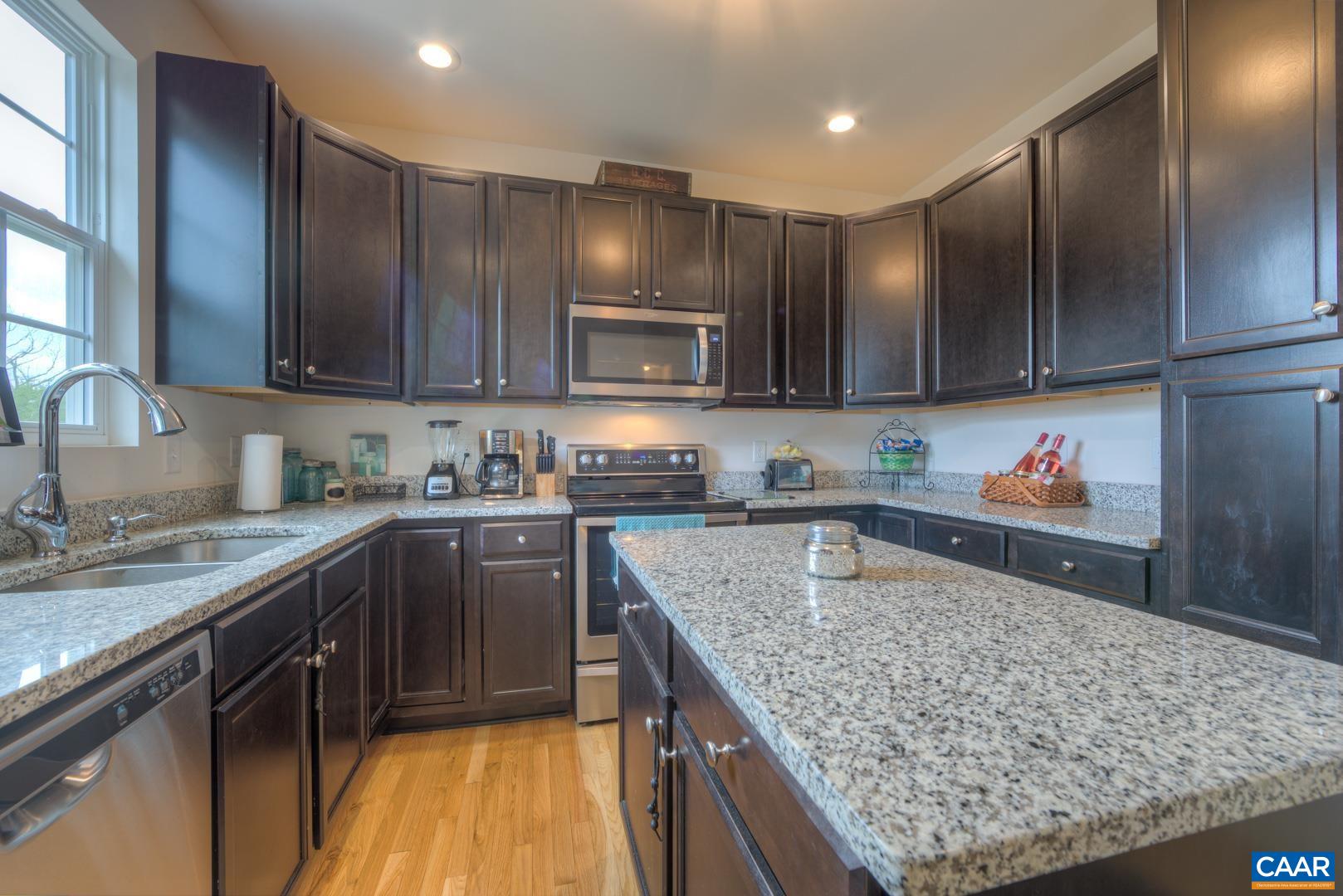 205 Cedar Run Road Ruckersville, VA 22968 - Photo 17 of 39 a kitchen with kitchen island granite countertop wooden cabinets counter top space and stainless steel appliances
