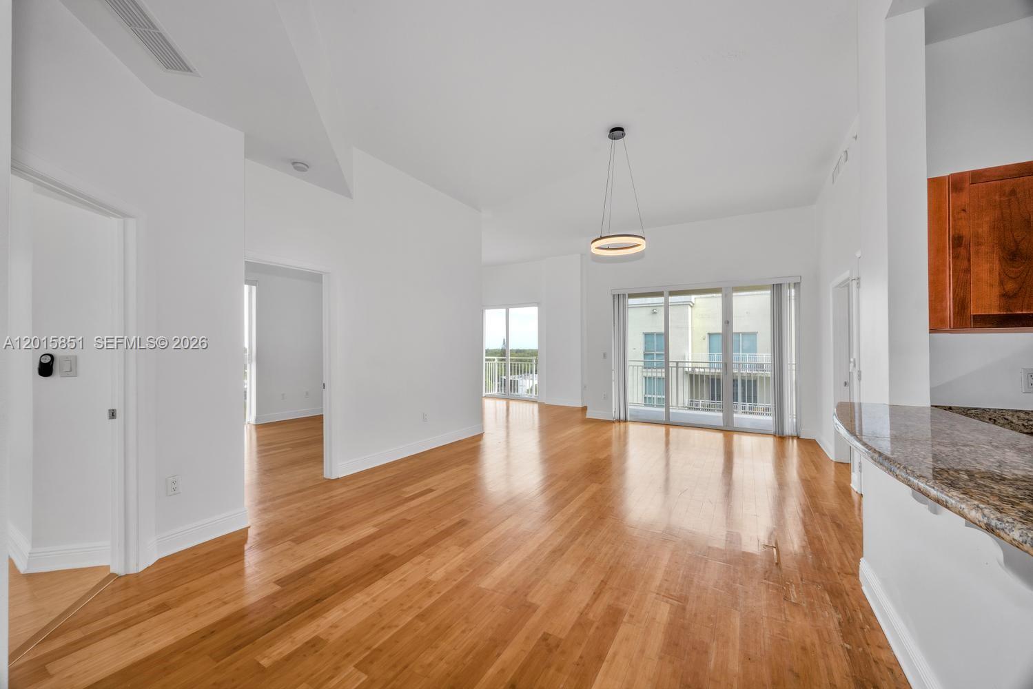 7275 Southwest 90th Street, Unit C719 Miami, FL 33156 - Photo 1 of 25 a view of empty room with wooden floor and fan
