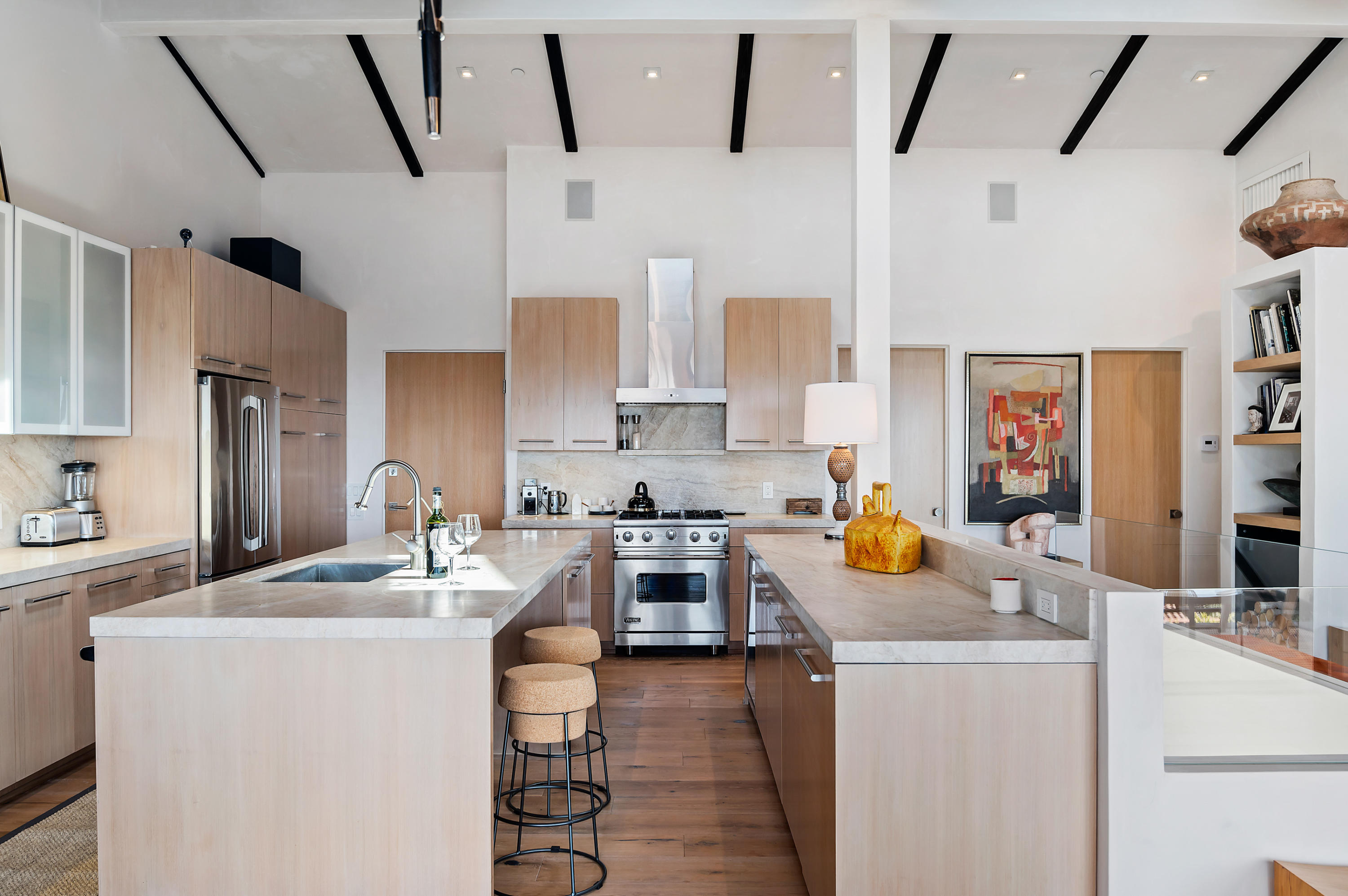 a kitchen with stainless steel appliances a stove a sink a refrigerator a counter space and cabinets