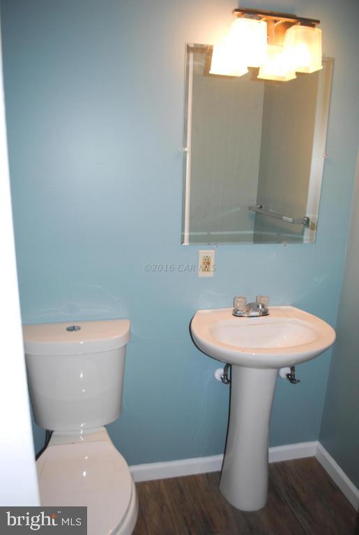 31140 McCormick Swamp Road Princess Anne, MD 21853 - Photo 14 of 20 a bathroom with a toilet sink and mirror