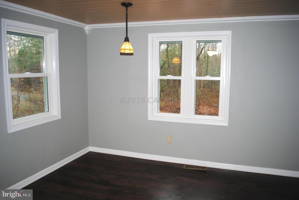 31140 McCormick Swamp Road Princess Anne, MD 21853 - Photo 7 of 20 a view of an empty room with wooden floor and a window