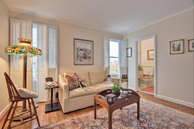a dining room with furniture a chandelier and window