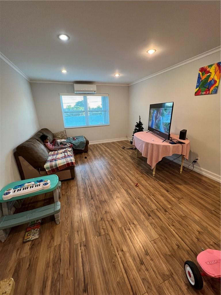 1250 East Sample Road, Unit 208 Pompano Beach, FL 33064 - Photo 12 of 19 a bedroom with furniture and a wooden floor