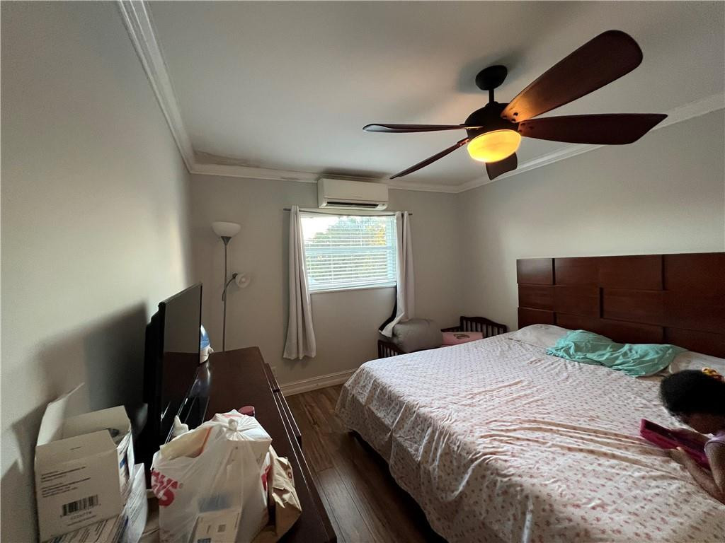 1250 East Sample Road, Unit 208 Pompano Beach, FL 33064 - Photo 15 of 19 a bedroom with a bed and ceiling fan