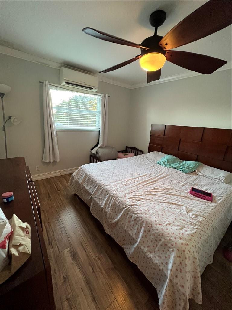 1250 East Sample Road, Unit 208 Pompano Beach, FL 33064 - Photo 16 of 19 a bedroom with a bed and a window