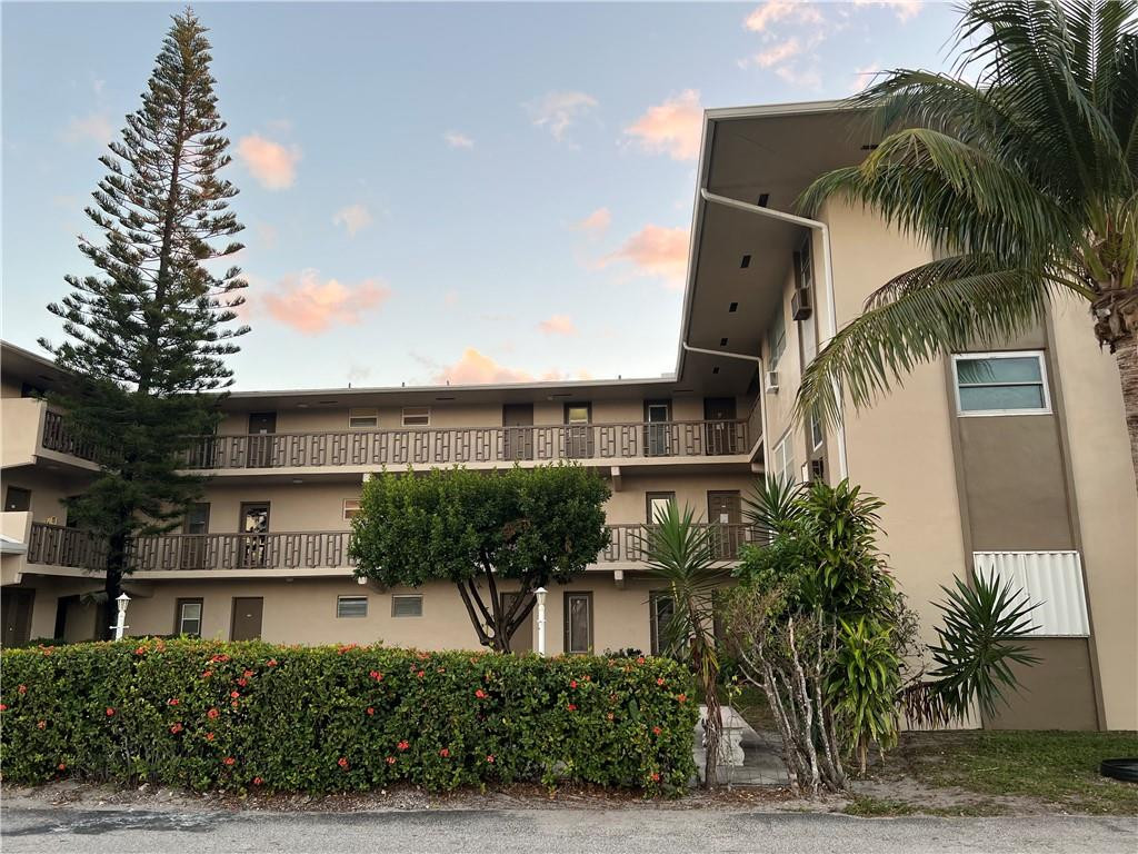 1250 East Sample Road, Unit 208 Pompano Beach, FL 33064 - Photo 19 of 19 a front view of multiple houses with yard