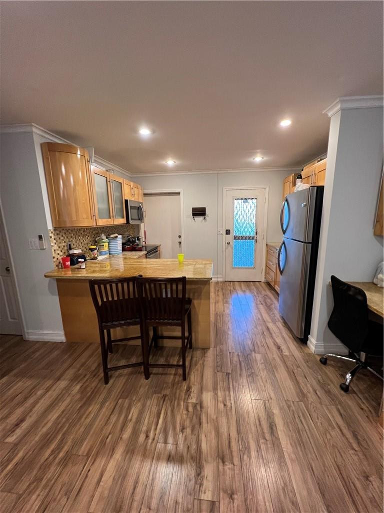 1250 East Sample Road, Unit 208 Pompano Beach, FL 33064 - Photo 2 of 19 a dining room with furniture and wooden floor