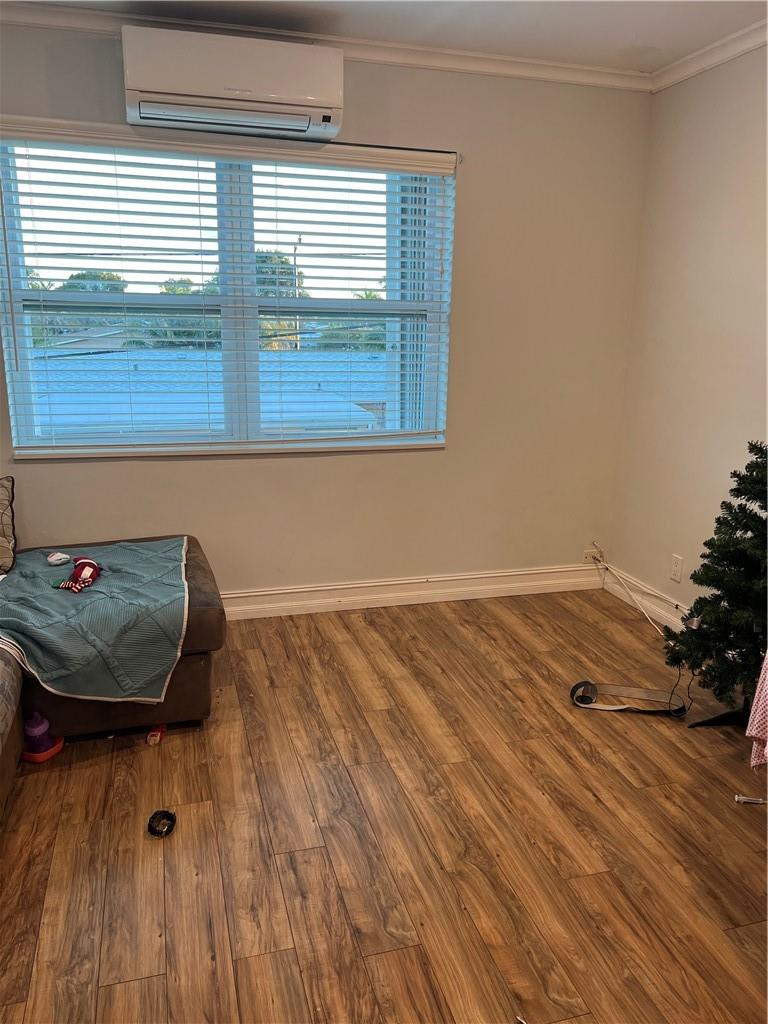 1250 East Sample Road, Unit 208 Pompano Beach, FL 33064 - Photo 10 of 19 a view of a room with wooden floor and cabinet