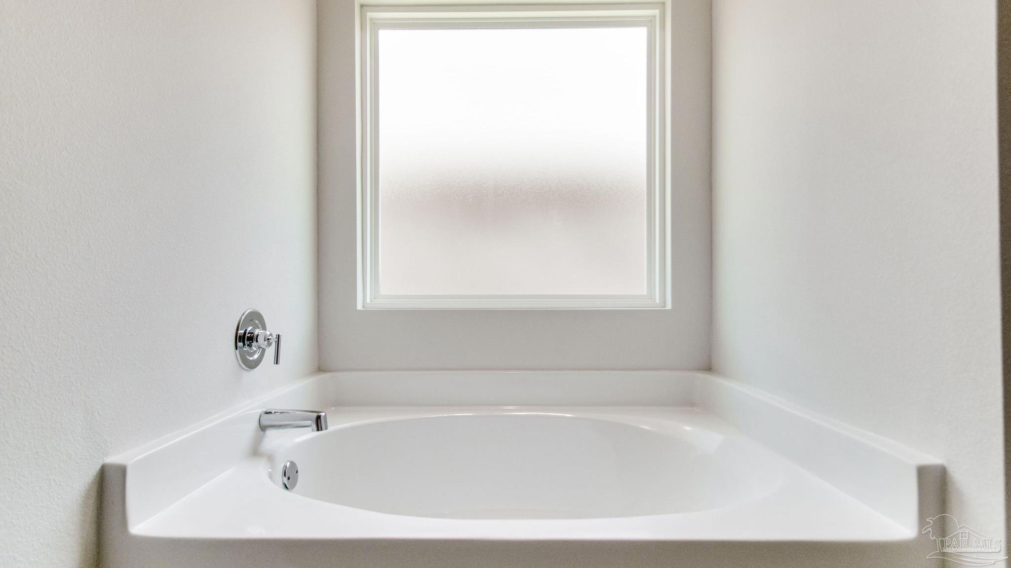 144 Albatross Street Cantonment, FL 32533 - Photo 21 of 31 a white bath tub sitting next to a window
